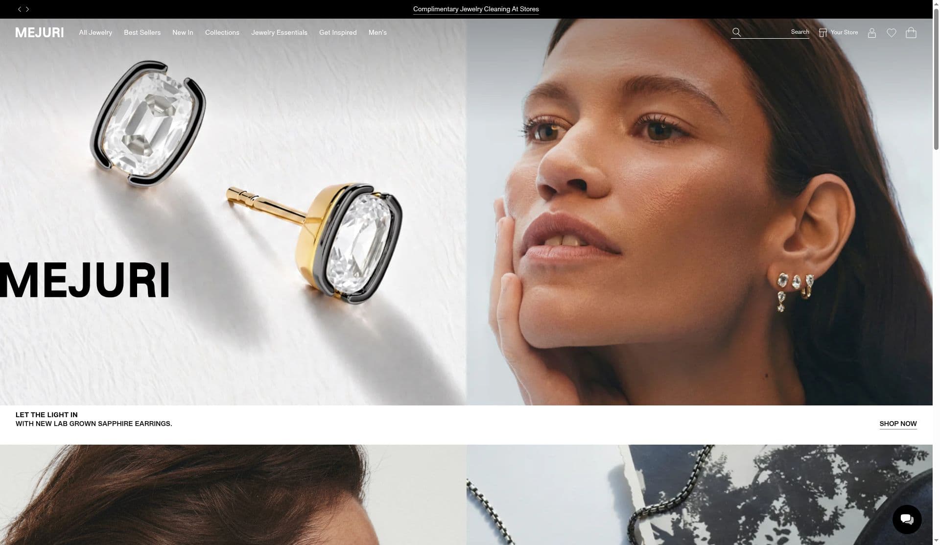 Mejuri homepage with a Complimentary Jewelry Cleaning At Stores banner and a chat bubble